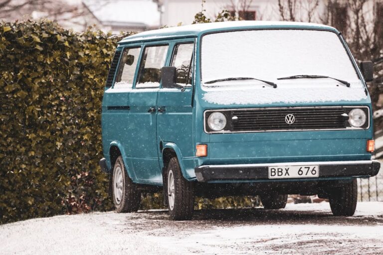 Classic Volkswagen van covered in snow, parked outdoors in Jönköping, Sweden.